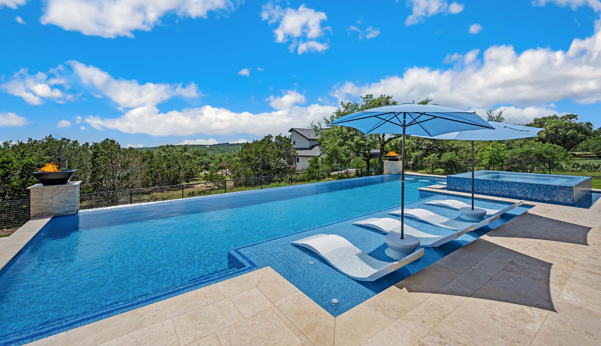 Professional pool service technician maintaining a swimming pool in San Antonio, Texas